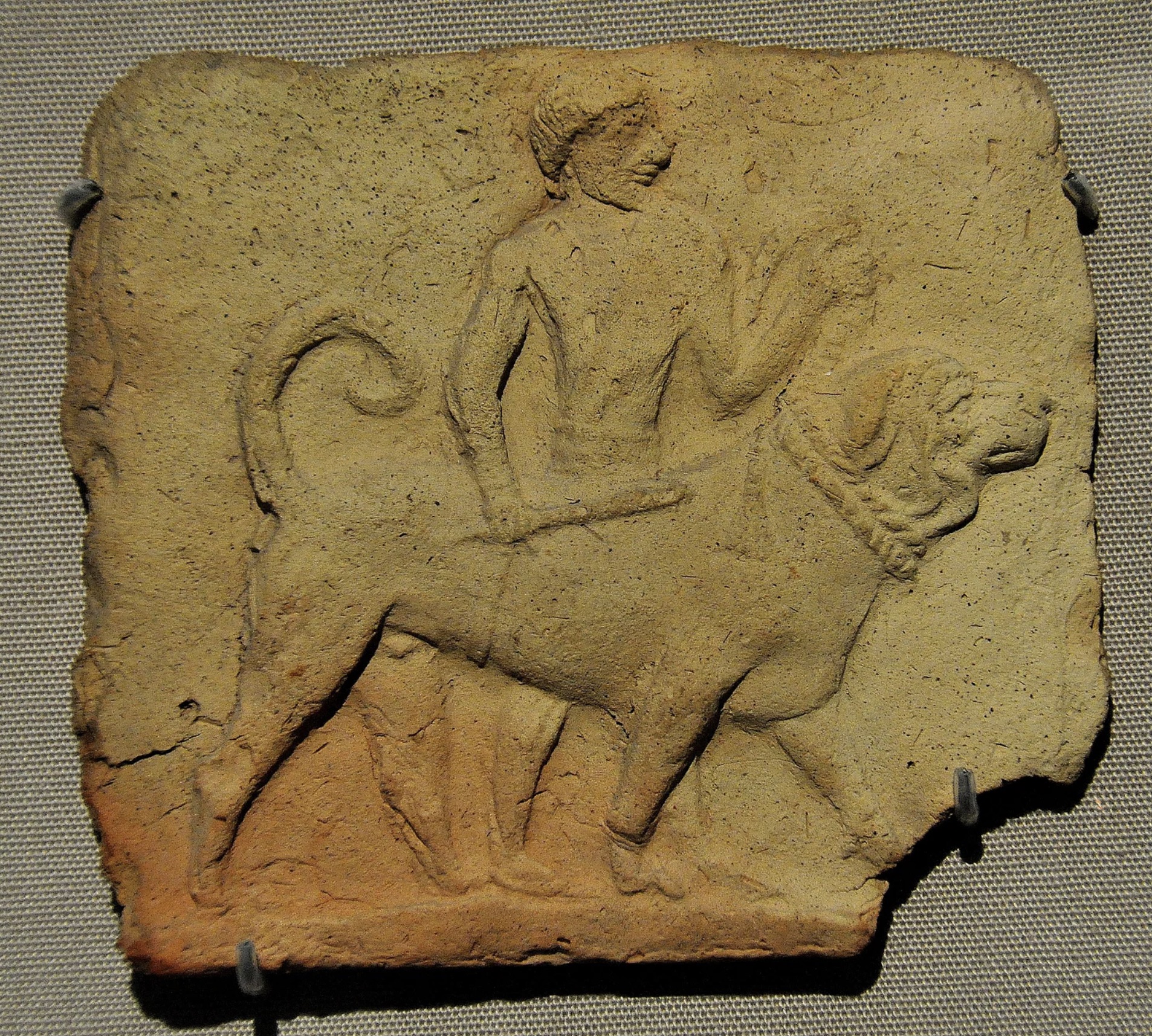 ancient carving of a huge middle eastern mastiff and owner
